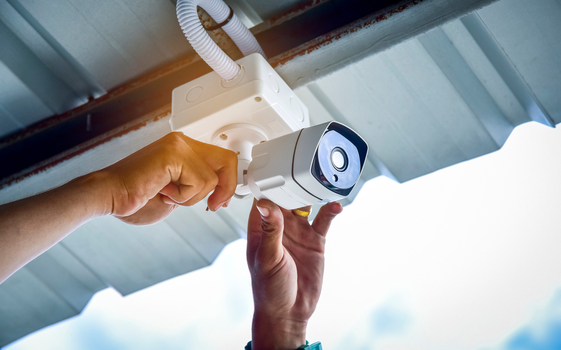 Technician installing CCTV camera for security